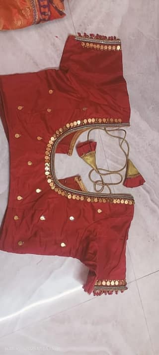 Red and gold embellished choli with mirror work and gota patti