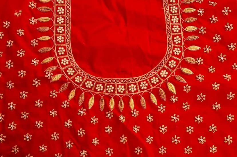 Red and gold embroidered blouse with intricate floral and leaf motifs, featuring a deep U-shaped neckline and pearl and sequin embellishments. view 4