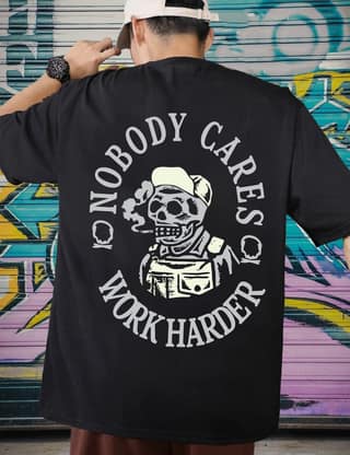 SCOTT FINCHER Men's Black cotton t-shirt with a white and red print of a skull in a hat and overalls smoking a cigarette with the text "Nobody cares, work harder" in a circle around it : AA(ARN)BLACK_271