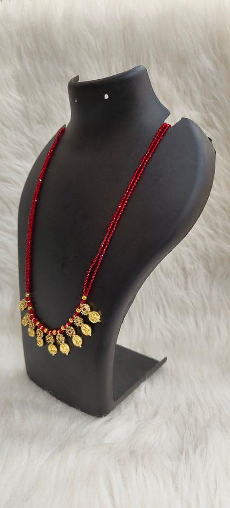 Delicate and elegant gold-plated long necklace with red beads and intricate detailing, perfect for any occasion. view 3