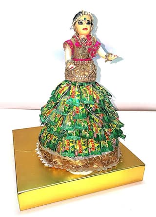 Bridal doll wearing a Pan Pasand candy wrapper dress