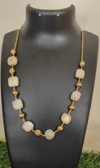 "Stunning Golden Beaded Necklace with a Floral Centerpiece"