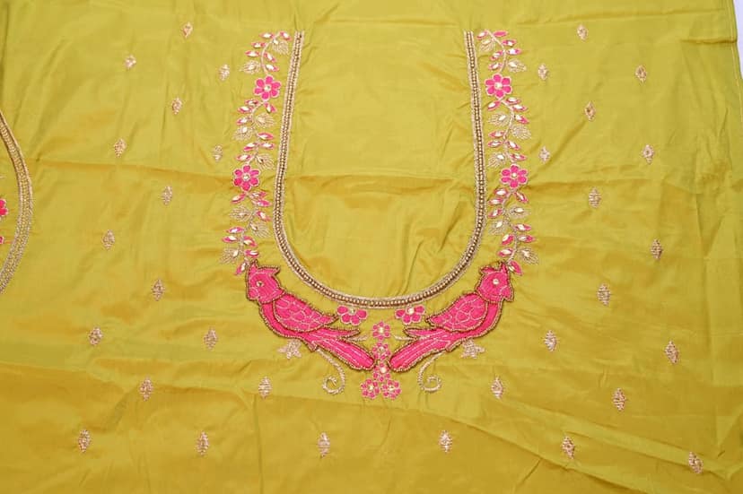 Green blouse with intricate embroidery and mirror work