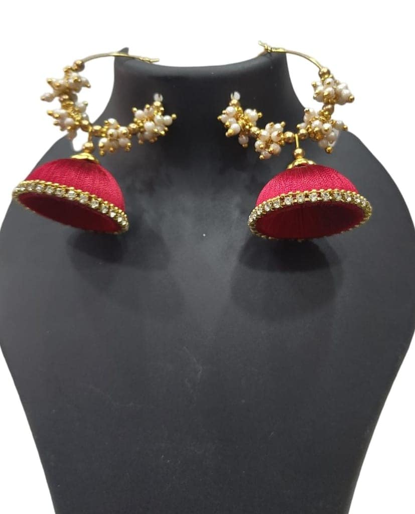 Red and gold jhumka earrings with pearl and kundan accents