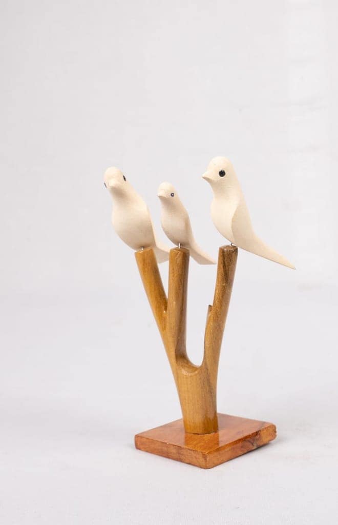 Three White Wooden Birds on a Branch