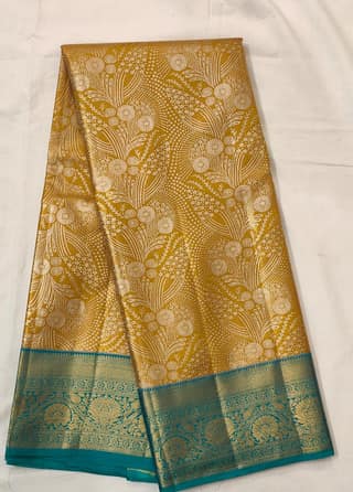 Suvarna Neelambari – Mustard Gold Zari Saree with Teal Border