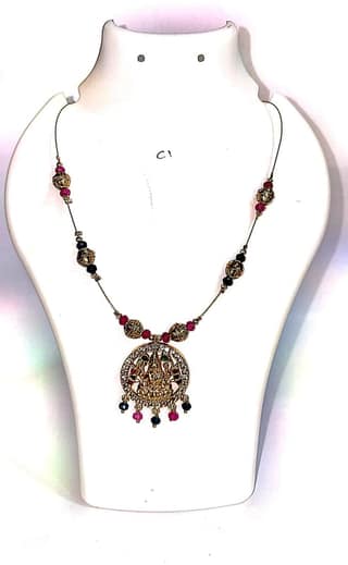 "Stunning antique gold plated traditional Indian necklace with intricate detailing and colorful gemstones."