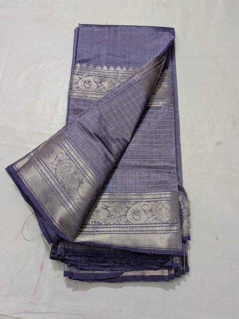 A beautiful, traditional Indian silk saree in a deep blue color with silver zari work.