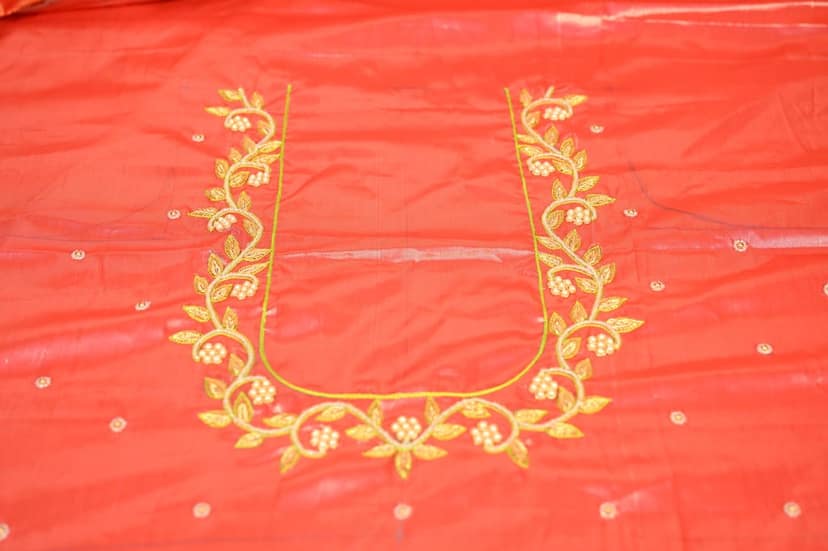 Red and gold embroidered blouse with floral design