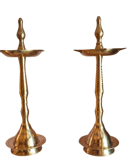 A pair of brass oil lamps with a traditional design