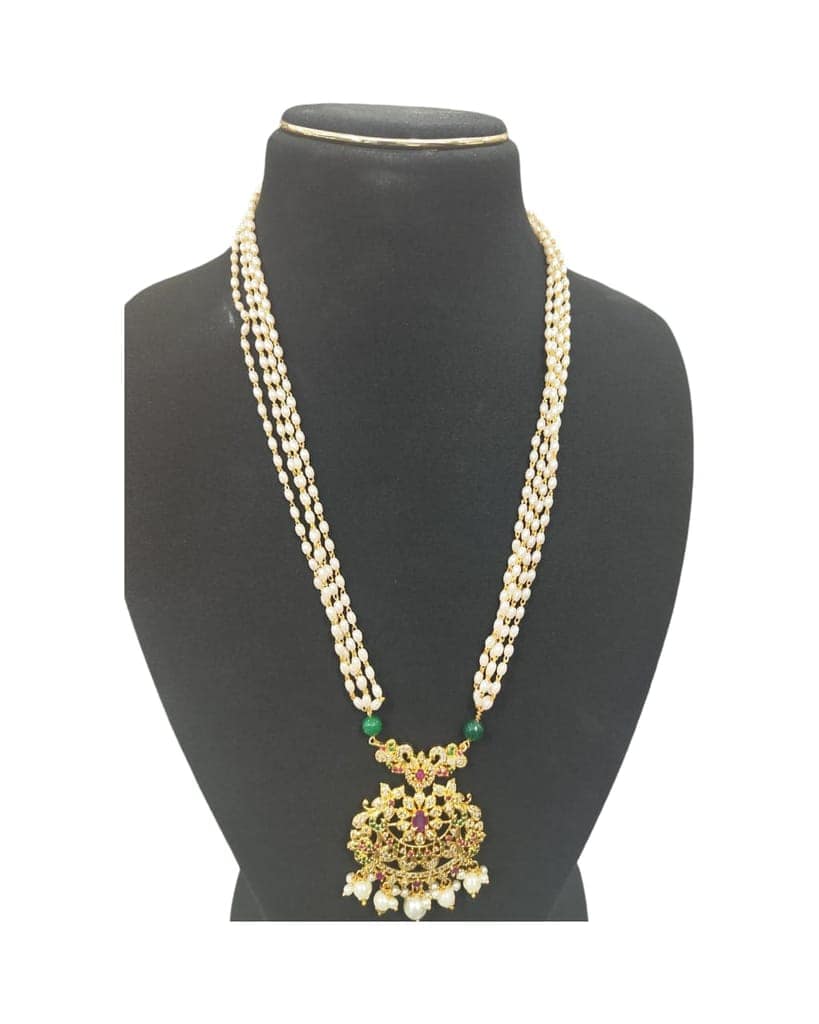 Pearl and gold necklace with intricate detailing and a floral pendant. view 2