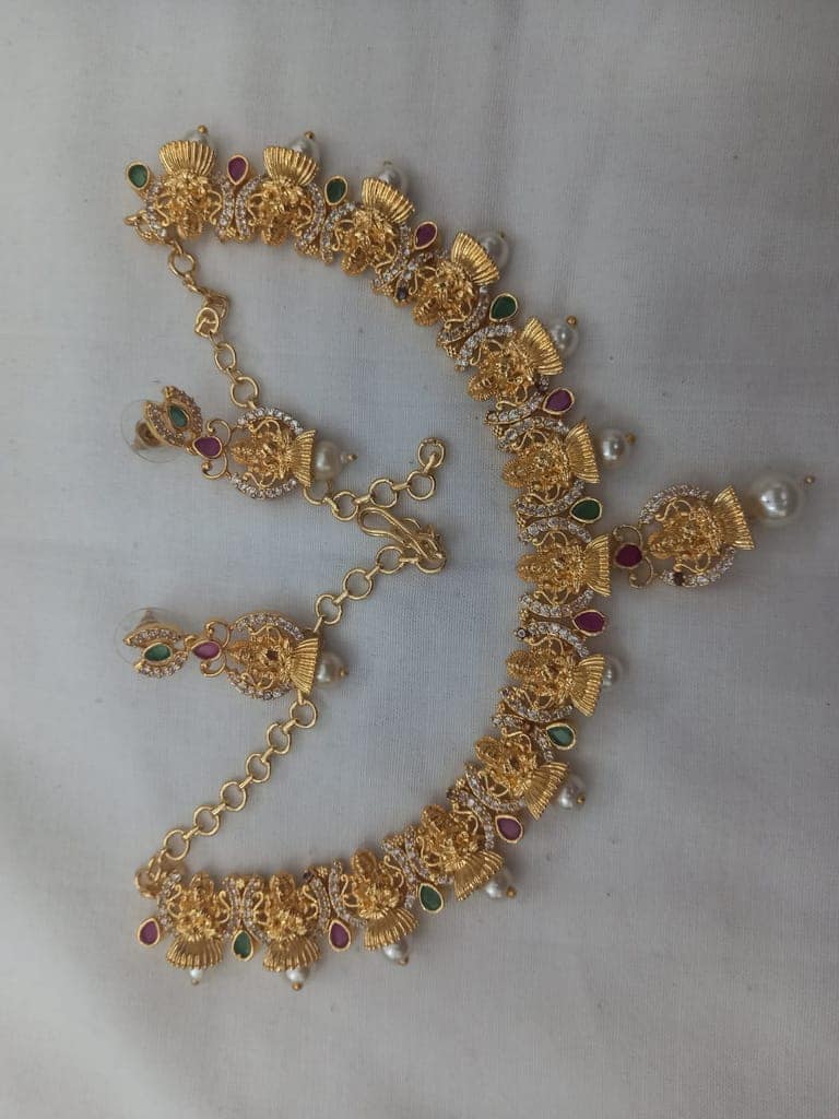 "Stunning Lakshmi Temple Jewelry Set in Gold with Pearls and Green Stones"