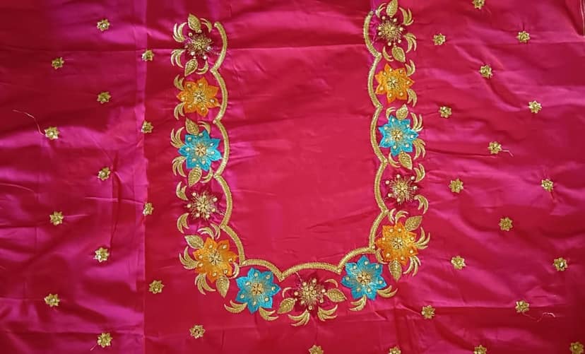 Red and gold embroidered blouse with floral motifs