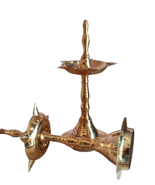 A pair of brass oil lamps with a traditional design