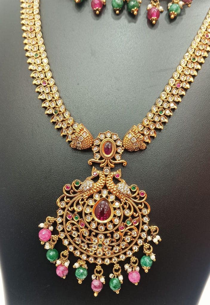 Gold-plated traditional Indian necklace set with intricate detailing and colorful stones view 2