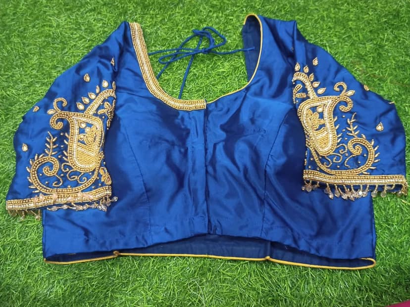Blue blouse with intricate golden embroidery and mirror work