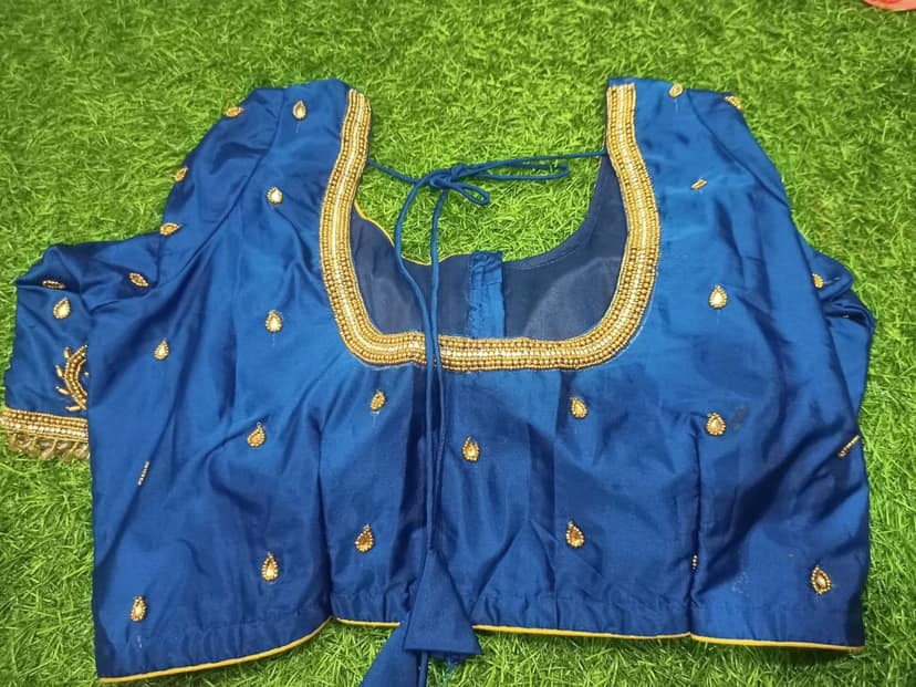 Blue blouse with intricate golden embroidery and mirror work view 2