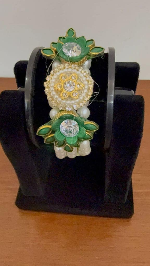An Elegant Green And Golden Lotus-themed Moti Pearl Bracelet Centered With Sparkling Crystals