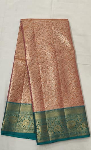 Neelambari Suvarna – Peach Copper Zari Saree with Fine Floral Jaal and Teal Border