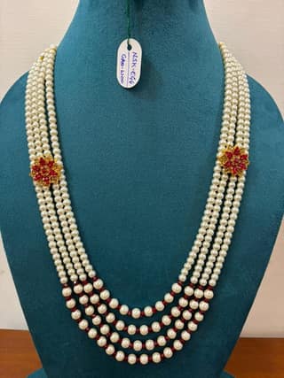 groom multi-strand white moti necklace featuring maroon pearl spacers and flower charm